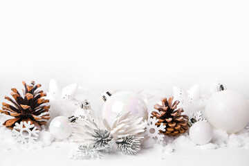Naklejka na ściany i meble Silver and white Christmas balls and ornaments on white snow background