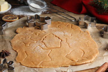 Making homemade Christmas cookies. Dough and cutters on table, closeup