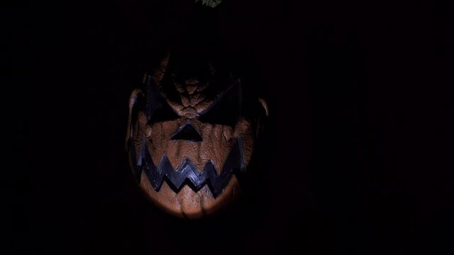 scary pumpkin head in the dark