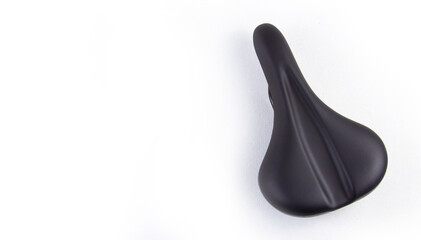 Bicycle saddle in black on a white background, close-up top view. copyspace for text.