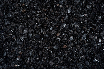 Top view of black textured abstract background. Burned  firewood with cinder or ash  backdrop.
