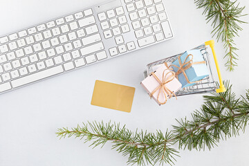 Online christmas shopping concept with gift boxes, keyboard and mockup of golden credit card