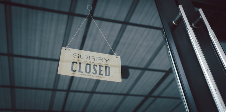 Closed sign in a shop showroom with reflections. sign showing the word " Closed ". Closing announcement concept Or stop the business, close the shop.