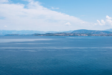 Fototapeta na wymiar A view towards mainland Greece from the Old Venetian Fortress in Corfu Town across the Ionian Sea