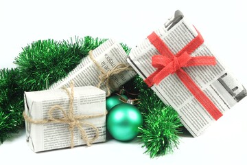 Gifts wrapped in old newspaper on white background