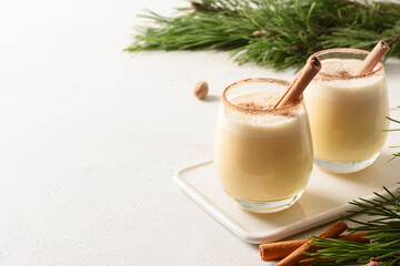 Traditional Christmas eggnog with grated nutmeg and cinnamon. Copy space.