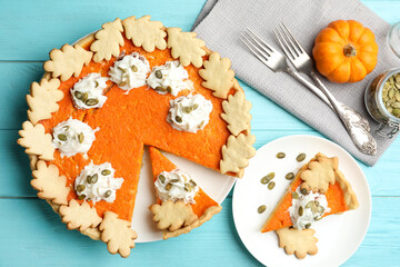 Delicious homemade pumpkin pie on light blue wooden table, flat lay