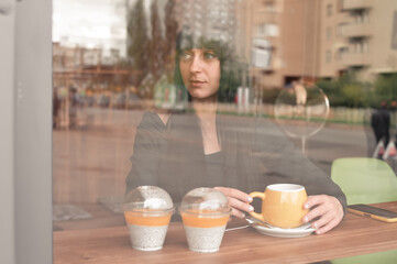 woman drinking coffee in cafe