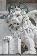 Winged lion with a Bible and a priest at Basilica San Marco in Venice, Italy, summer time, details, closeup