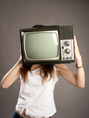 young woman with old retro tv