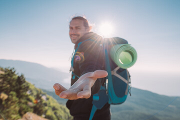 A tourist stands on the top of a mountain at dawn, calling for him