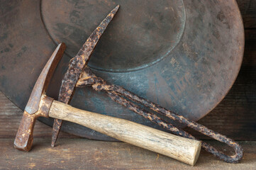 Gold pan with old pick axes and space for text message.
Closeup.