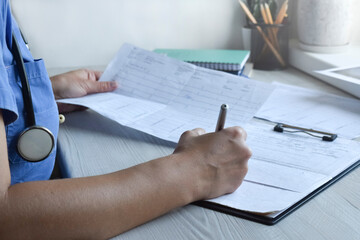 Young girl doctor at her desk prescribes a prescription for treatment: healthcare concept