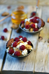 Selective focus. A healthy dessert with mascarpone cheese, biscuits and raspberries.