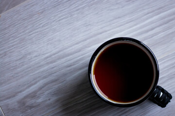 a cup of tea on a light wooden background