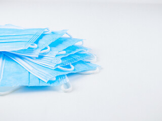 
medical masks isolated on white.
Medical masks, isolated lie on the left on a white background with a place for the text on the right, close-up side view.