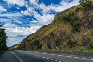 Driving between rocks. Beautiful Country roads and nature. The road between the rocks leading to the mountains.