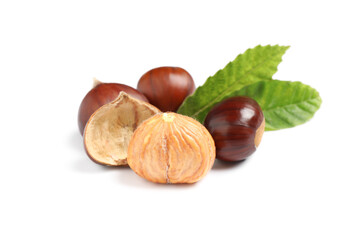 Fresh sweet edible chestnuts with green leaves on white background