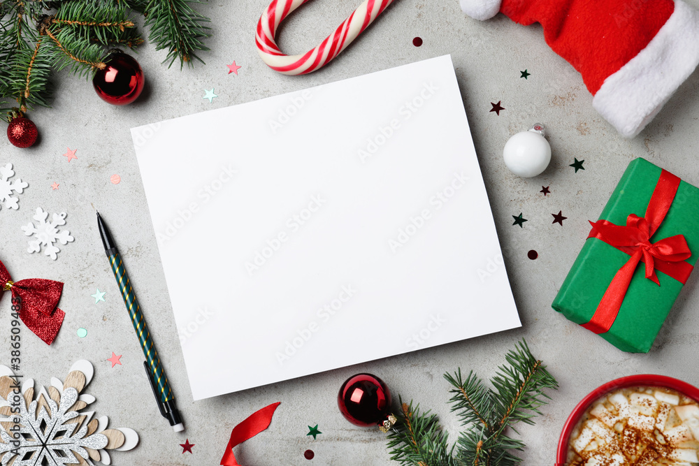 Wall mural Flat lay composition with Christmas decor and blank card on grey background. Space for text