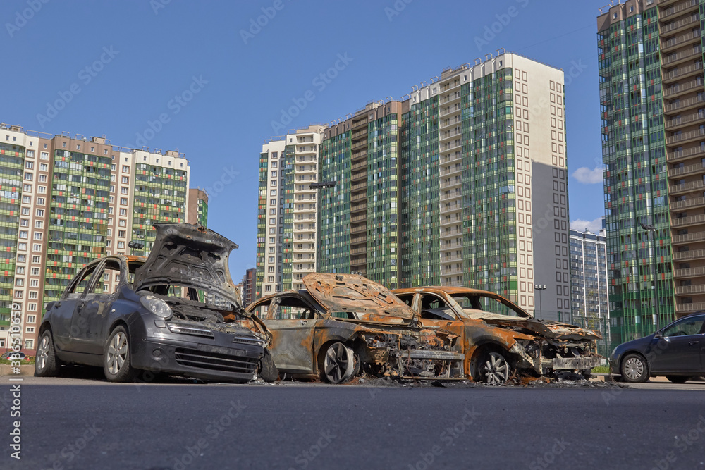 Wall mural city burned cars after a fire in one of the city's districts