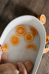 hand holding a bowl of orange juice