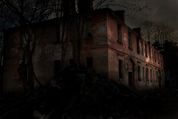 Fototapeta na wymiar scary abandoned building with dark Windows at sunset