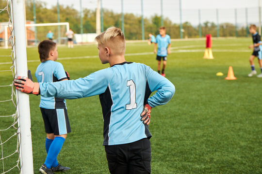 rear view on young kid boy having rest during football game, sportive children in stadium - Powered by Adobe