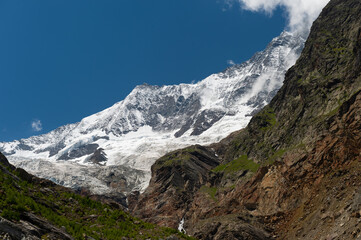 Fototapeta na wymiar Majectic Täschhorn (4491m) and Dom (4545m) alpine mountain peaks and Fee glacier on top of Saas valley, Valais, Switzerland