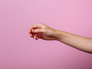 Instruction: how to hold chopsticks eat with chopsticks. Isolated on pink background. step 1.