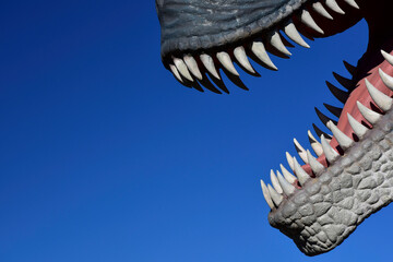 T rex teeth against blue sky background