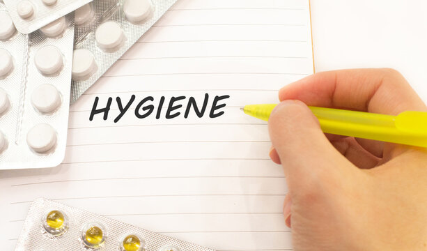 Text hygiene on white background. There are various pills and vitamins around. Medicine concept