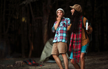 Shot of a happy couple camping on the nature. Couple in love. Camping photo. Romantic lovers. Fun. Life. 