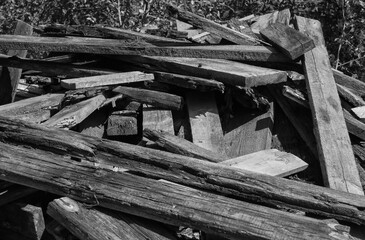 a dump of old rotten boards. black and white