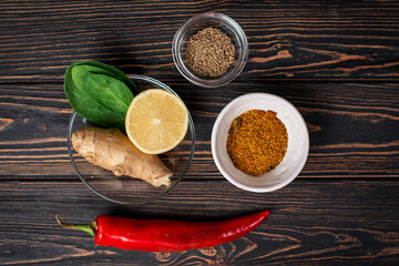 Traditional Indian, asian ingredients: spices for making curry, soup. Chilli pepper, turmeric, lemon, ginger, herbs. 