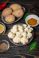 Aloo Gobi Ingredient set. Traditional spicy vegetarian indian curry dish with potatoes, cauliflower, spinach with spices