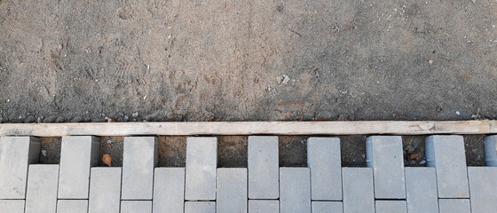Building an pedestrian path with paver bricks. Sidewalk pavement