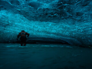 A scientist traversing the river in a cave in the Hansbreen Glacier. 
Norway, Svalbard, Hornsund.