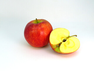 Red apple and half an apple on white background.    