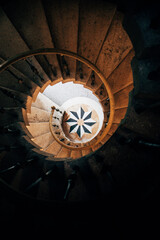 View down a Spiral staircase to mosaic at the bottom