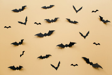 Halloween decorations with bats on pastel beige background. Halloween concept. Flat lay, top view, copy space