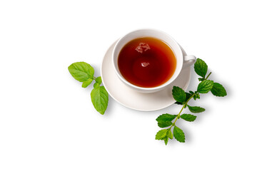 A Cup of black tea on a saucer with mint leaves on a white isolated background. Space for copying.