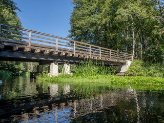 Fototapeta na wymiar Wooden bridge on the river