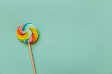 colorful candy on a stick on a blue background