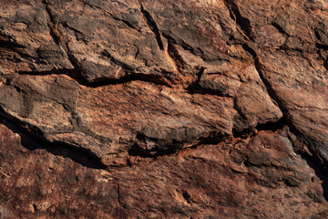 Brown cracked surface stone texture. Solid concept. Abstract natural pattern for design. Textured background for interior decoration or packaging.