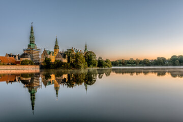 Fototapeta na wymiar the calm lake of Frederiksborg with reflections of the castle at sunrise