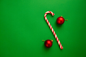 Christmas toys and candies on a green background