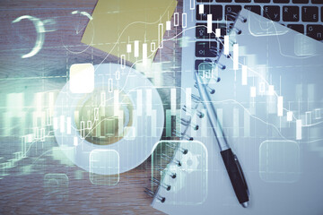 Double exposure of forex chart drawing over table background with computer. Concept of financial research and analysis. Top view.