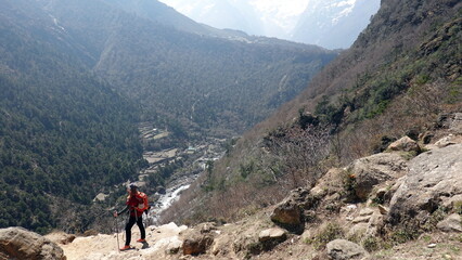 Fototapeta na wymiar Backpacker woman hiking and trekking in the Nepal mountains around Everest.