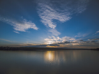 Sunset over a river with forest on a horizon. Almost dusk.
