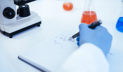 Fototapeta premium close up. scientist looking at a drop of blood through a microscope.